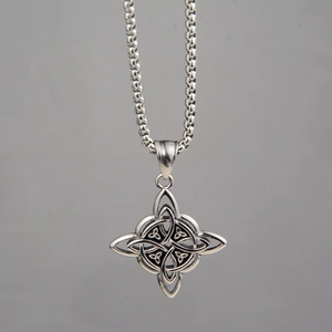 Macro shot of silver Celtic Knot pendant with vintage finish on a round box chain
