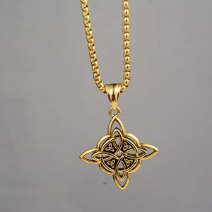 Detail of golden Viking Celtic knot pendant with square box chain on gray background