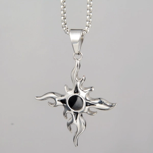 Detailed macro view of a silver flame cross pendant with a black center on a box chain
