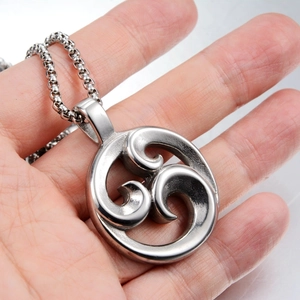 Macro shot of silver titanium steel necklace featuring a hollowed-out spiral cloud pendant
