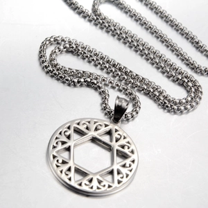 Detailed close-up of a silver hollow hexagram star pendant with intricate scroll patterns