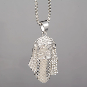 Detailed close-up of hip-hop Pharaoh pendant with white rhinestones and silver box chain