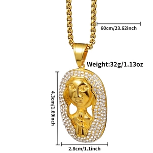 Macro shot of gold Pharaoh pendant with size dimensions and shimmering crystals
