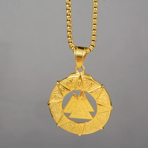 Detailed close-up of a golden Valknut pendant necklace with Norse geometric patterns