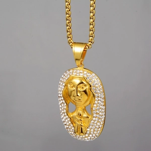 Macro view of gold pharaoh pendant with shimmering crystal edges and thick metal chain
