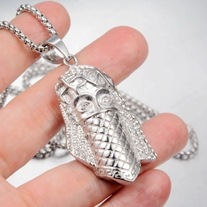 Detailed view of silver hip hop pharaoh pendant necklace with sparkling white crystals