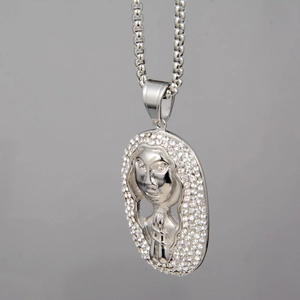 Detailed close-up of a silver pharaoh pendant with shimmering rhinestone embellishments