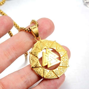Macro detail of golden Viking Valknut pendant featuring intricate runic geometry textures