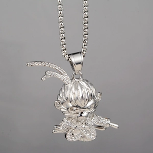 Macro shot of a silver Monkey King pendant fully iced out with sparkling white crystals