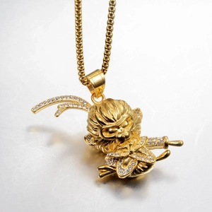 Detailed macro shot of golden Monkey King pendant with white crystal diamonds