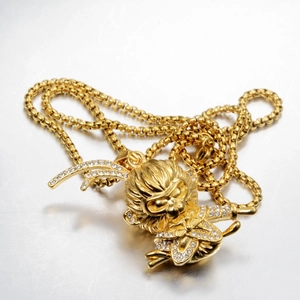 Close-up of golden Monkey King pendant with sparkling crystal details and box chain