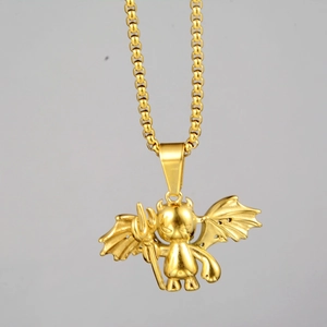 Detail of a golden cartoon devil pendant with trident and wings on a matching chain