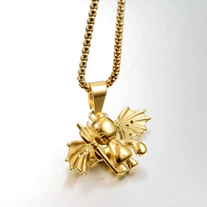 Close-up of golden little devil pendant with wings and trident on a box chain