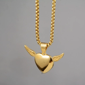 Detail of the golden box chain with heart and wings pendant showing feather texture