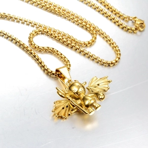 Macro shot of a gold-plated cartoon angel pendant on a sturdy round box chain necklace