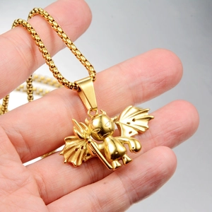 Detailed close-up of golden little devil pendant with wings and trident on round box chain