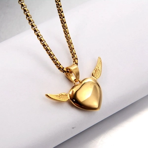 Detailed macro view of the golden heart pendant with intricate wings on a box chain necklace
