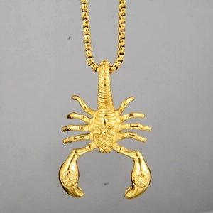 Detailed close-up of a golden scorpion pendant with realistic segmented body and box chain