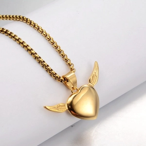 Detailed close-up of a gold-plated winged heart pendant on a round box chain necklace