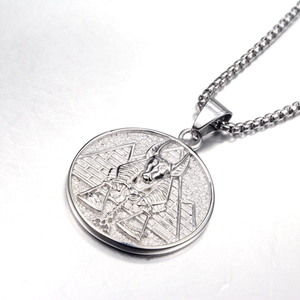 Macro shot of silver Pharaoh Anubis medallion with box chain and pyramid detail
