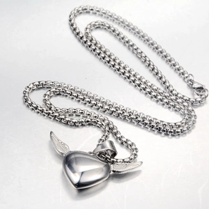 Detailed view of polished heart wing pendant on a sturdy round box chain necklace