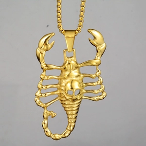Macro shot of gold plated scorpion pendant with skull detail and metal chain