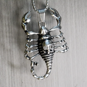 Detail of silver scorpion skull pendant on beaded chain with gothic punk design
