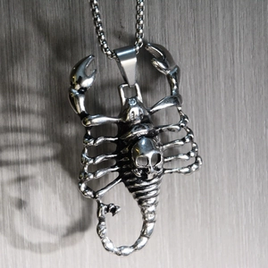 Detailed macro view of vintage punk scorpion pendant necklace with skull design
