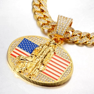 Vue macro d'un collier chaîne cubaine dorée avec pendentif cowboy drapeau américain