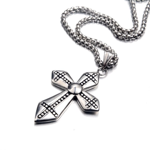 Hip hop gothic cross necklace in polished stainless steel with box chain on white surface