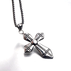Gothic silver cross pendant necklace with black polka dot patterns and bead chain