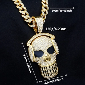 Macro detail of gold hip hop skull pendant with rhinestones and 50cm cuban chain