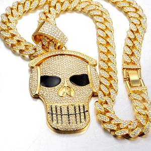 Hip hop style gold-plated skull pendant with headphones and crystals on a Cuban link chain