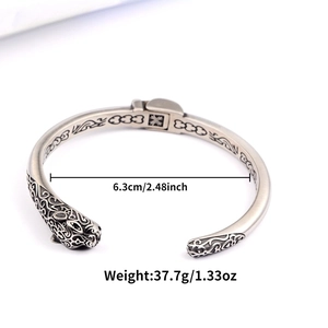Detailed view of vintage cheetah cuff with intricate carvings and dimensions shown