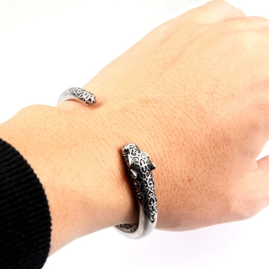 Vintage cheetah head open cuff bracelet with intricate floral engravings in stainless steel