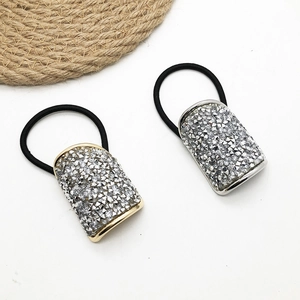 U-shaped crystal hair ties with gold and silver rhinestone bases on black elastic bands