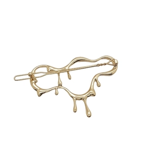 Golden irregular liquid metal hair clip with a vintage molten aesthetic for women