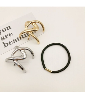 Minimalist gold and silver twisted knot metal hair clips with elastic hair tie on white