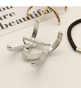 Detail of silver S925 minimalist hair hook showing sleek curved metal and secure fixing hook