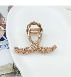 Macro detail of rose gold hollow chain braided metal shark hair claw clip with strong spring