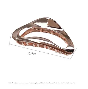 Detail view of 10.5cm large rose gold metal hair claw clip with glossy geometric design