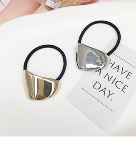 Detail of high-elasticity hair ties with polished gold and silver pebble metal accents