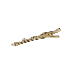 Minimalist gold-plated hair clip with white pearl accent on a clean white background