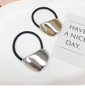 Detail of high-elasticity hair ties with gold and silver irregular metallic accents