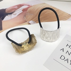Set of minimalist gold and silver hair ties with textured metal semi-arc accents for women