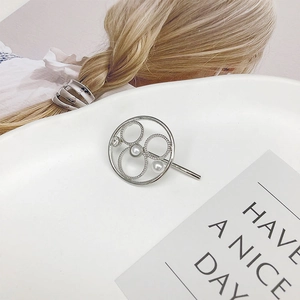 Silver ponytail cuff with nested rings, white pearls and sparkling diamond accent