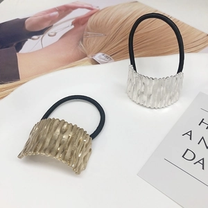 Minimalist metal hair ties set in gold and silver with textured matte finish design