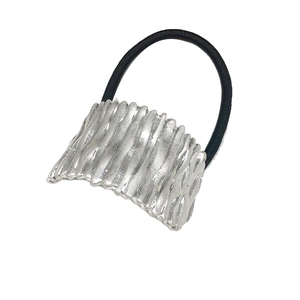 Minimalist elastic hair tie with silver metallic textured wave ornament on white background