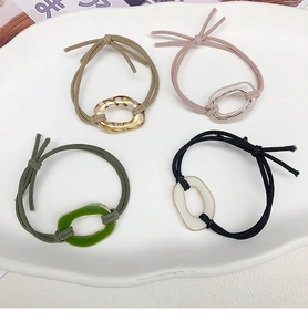 Close-up of four minimalist high-elastic hair ties with marble-textured resin rings