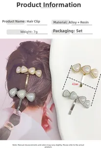Macro view of 42mm triangle hair hook hair clip in gold alloy with white resin pearl inlay